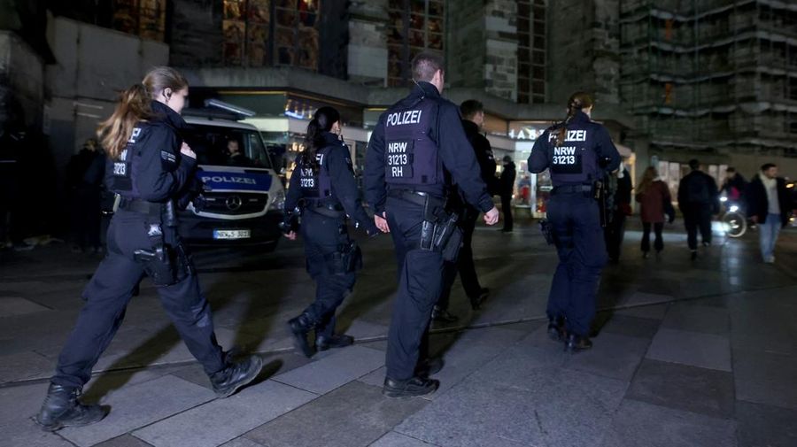 German police walk in front of the cathedral in central Cologne, Germany, December 23, 2023.     REUTERS/Thilo Schmuelgen