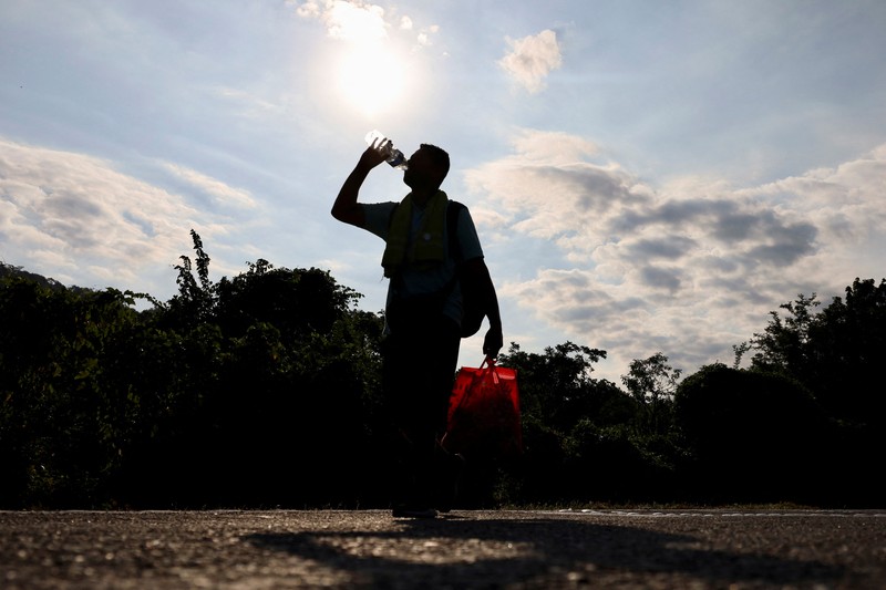 Migrants walk as they leave Tapachula in a caravan to attempt to reach the U.S. border, in the state of Chiapas, Mexico December 24, 2023. REUTERS/Jose Torres