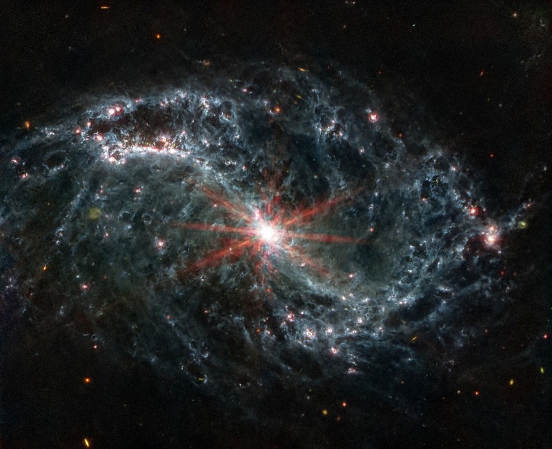 Intricate networks of gas and dust featured in the web-like spiral galaxy NGC 7496 are seen in a composite image taken by the James Webb Telescope and released by NASA on February 16, 2023. Eight red diffraction spikes extend out from its extremely bright core. Colorful dots in the background represent background galaxies. NASA/ESA/Handout via REUTERS   THIS IMAGE HAS BEEN SUPPLIED BY A THIRD PARTY