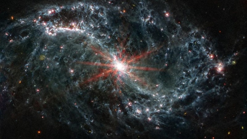 Intricate networks of gas and dust featured in the web-like spiral galaxy NGC 7496 are seen in a composite image taken by the James Webb Telescope and released by NASA on February 16, 2023. Eight red diffraction spikes extend out from its extremely bright core. Colorful dots in the background represent background galaxies. NASA/ESA/Handout via REUTERS   THIS IMAGE HAS BEEN SUPPLIED BY A THIRD PARTY