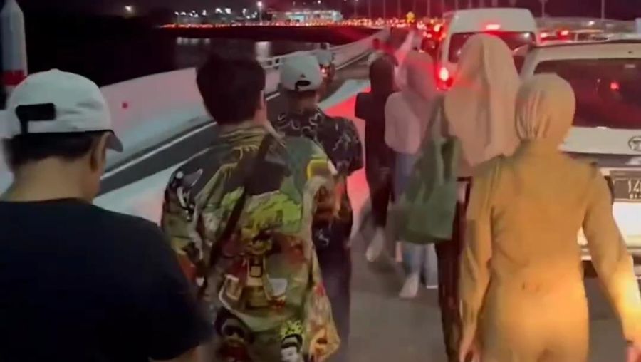 Penumpang terpaksa jalan kaki dan mengangkat koper menuju Bandara Ngurah Rai karena terjebak macet di tol. (Dok. Detikcom/Agus Eka Purna Negara)