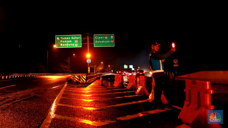 Petugas Jasa Marga sedang melakukan pengalihan arus kendaraan di Simpang Polingga KM 46 Tol Jagorawi, pintu GT Ciawi, Kabupaten Bogor, Jawa Barat, Sabtu (31/12/2022). Petugas Jasa Marga sedang melakukan pengalihan arus kendaraan di Simpang Polingga KM 46 Tol Jagorawi, pintu GT Ciawi, Kabupaten Bogor, Jawa Barat, Sabtu (31/12/2022). (CNBC Indonesia/Muhammad Sabki)