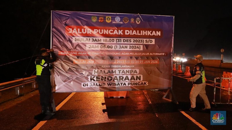 Petugas Jasa Marga sedang melakukan pengalihan arus kendaraan di Simpang Polingga KM 46 Tol Jagorawi, pintu GT Ciawi, Kabupaten Bogor, Jawa Barat, Sabtu (31/12/2022). (CNBC Indonesia/Muhammad Sabki)