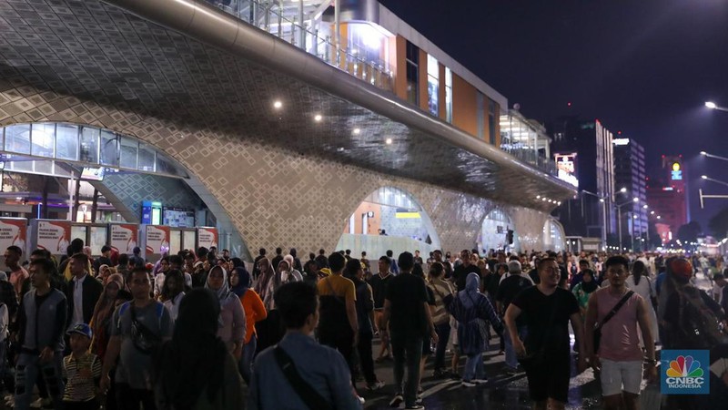 Warga memadati Car Free Night (CFN) perayaan malam Tahun Baru 2024 di kawasan Bundaran Hotel Indonesia (HI), Jakarta, Minggu (31/12/2023). (CNBC Indonesia/Faisal Rahman)