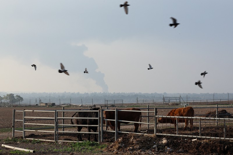 An Israeli soldier walks by tanks, amid the ongoing conflict between Israel and the Palestinian Islamist group Hamas, near the Israel-Gaza border, in southern Israel, January 1, 2024. REUTERS/Violeta Santos Moura