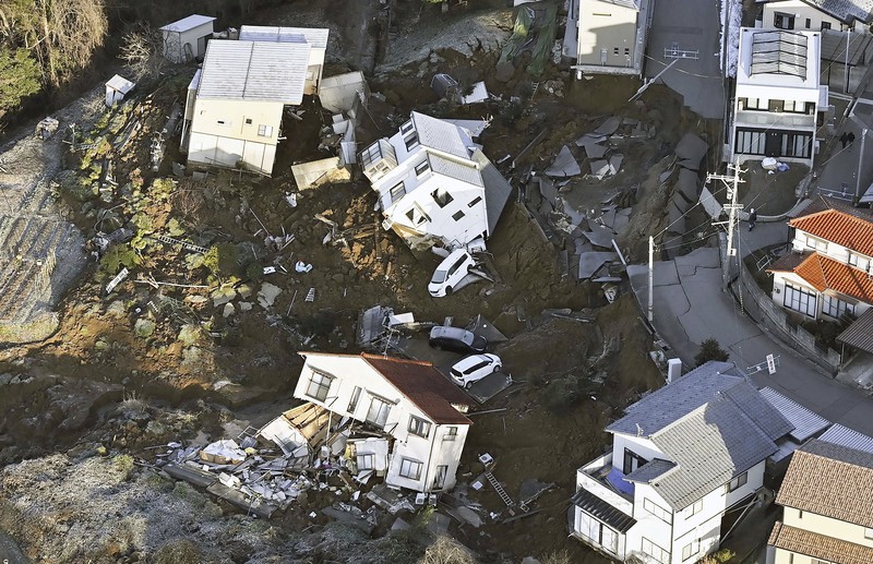 Japan Earthquake A building falls on the ground following an earthquake in Wajima, Ishikawa prefecture, Japan Tuesday, Jan. 2, 2024. A series of powerful earthquakes in western Japan damaged homes, cars and boats, with officials warning people on Tuesday to stay away from their homes in some areas because of a continuing risk of major quakes and tsunamis. (Kyodo News via AP)