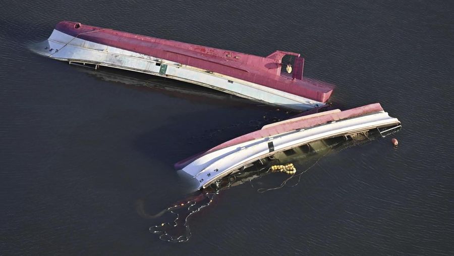 A building falls on the ground following an earthquake in Wajima, Ishikawa prefecture, Japan Tuesday, Jan. 2, 2024. A series of powerful earthquakes in western Japan damaged homes, cars and boats, with officials warning people on Tuesday to stay away from their homes in some areas because of a continuing risk of major quakes and tsunamis. (Kyodo News via AP)