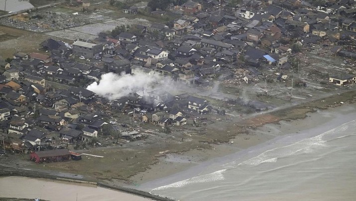 This shows an area affected by an earthquake in Suzu, Ishikawa prefecture, Japan Tuesday, Jan. 2, 2024. A series of powerful earthquakes in western Japan damaged homes, cars and boats, with officials warning people on Tuesday to stay away from their homes in some areas because of a continuing risk of major quakes and tsunamis. (Kyodo News via AP)