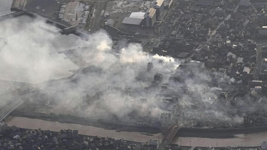 Smoke rises from the site of a fire occurred following an earthquake in Wajima, Ishikawa prefecture, Japan Tuesday, Jan. 2, 2024. A series of powerful earthquakes in western Japan left at least four people dead and damaged homes, cars and boats, with officials warning people on Tuesday to stay away from their homes in some areas because of a continuing risk of major quakes and tsunamis. (Kyodo News via AP)