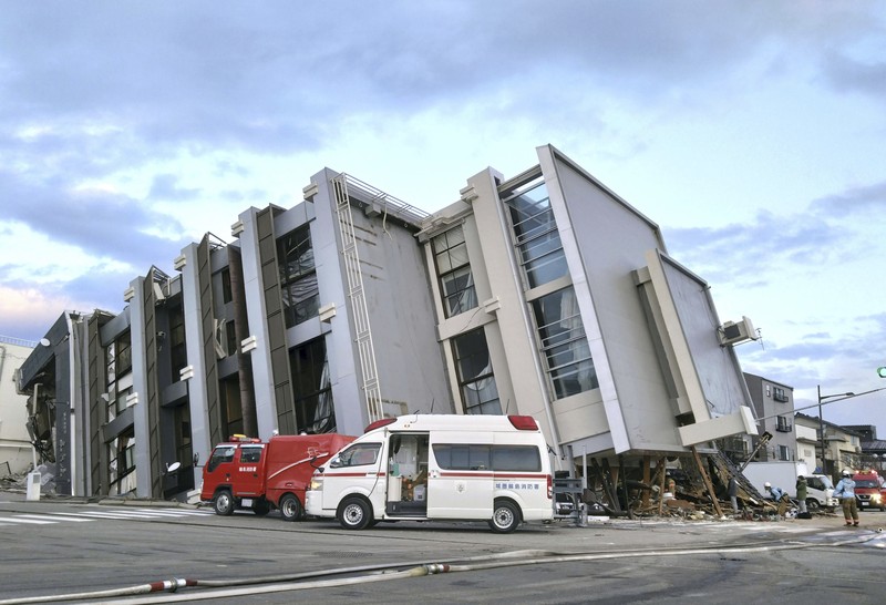 Japan Earthquake A building falls on the ground following an earthquake in Wajima, Ishikawa prefecture, Japan Tuesday, Jan. 2, 2024. A series of powerful earthquakes in western Japan damaged homes, cars and boats, with officials warning people on Tuesday to stay away from their homes in some areas because of a continuing risk of major quakes and tsunamis. (Kyodo News via AP)