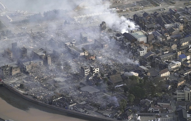 Japan Earthquake A building falls on the ground following an earthquake in Wajima, Ishikawa prefecture, Japan Tuesday, Jan. 2, 2024. A series of powerful earthquakes in western Japan damaged homes, cars and boats, with officials warning people on Tuesday to stay away from their homes in some areas because of a continuing risk of major quakes and tsunamis. (Kyodo News via AP)