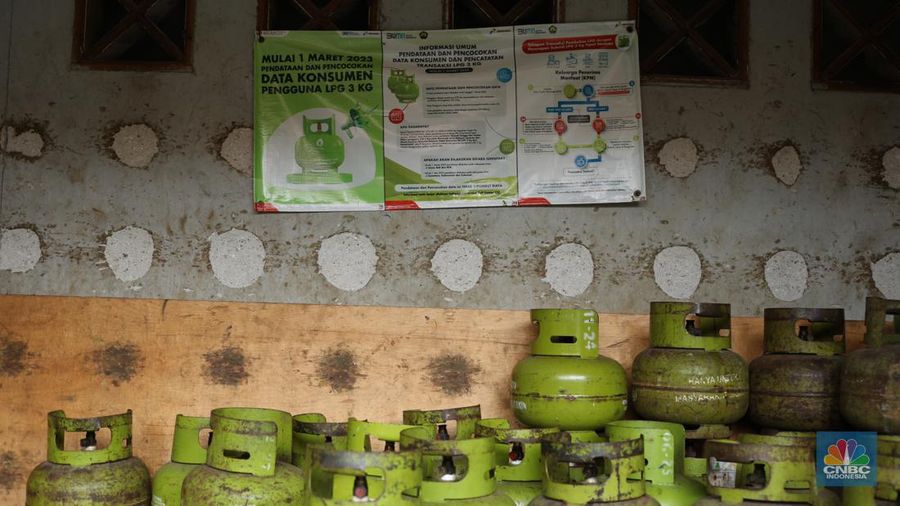 Pekerja menurunkan Liquefied Petroleum Gas (LPG) bersubsidi tabung 3 kilogram (kg) dari truk di pangkalan resmi LPG 3 kg Pertamina di Kawasan Jakarta, Selasa (2/1/2024). (CNBC Indonesia/Tri Susilo)