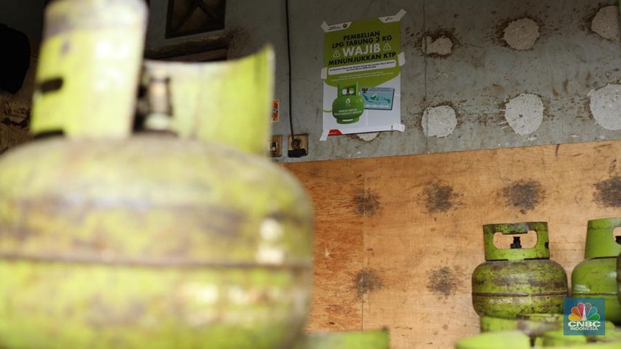 Pekerja menurunkan Liquefied Petroleum Gas (LPG) bersubsidi tabung 3 kilogram (kg) dari truk di pangkalan resmi LPG 3 kg Pertamina di Kawasan Jakarta, Selasa (2/1/2024). (CNBC Indonesia/Tri Susilo)