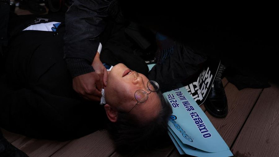 South Korea's opposition Democratic Party leader Lee Jae-myung falls after being attacked by an unidentified man during his visit to Busan, South Korea, January 1, 2024. Yonhap via REUTERS THIS IMAGE HAS BEEN SUPPLIED BY A THIRD PARTY. NO RESALES. NO ARCHIVES. SOUTH KOREA OUT. NO COMMERCIAL OR EDITORIAL SALES IN SOUTH KOREA.