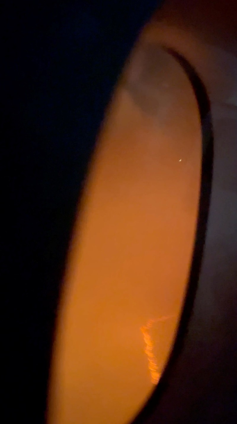 JAPAN-AIRPORT/FIRE People sit amid smoke inside the Japan Airlines' A350 airplane in this screen grab obtained from social media video. Video Obtained by Reuters/via REUTERS THIS IMAGE HAS BEEN SUPPLIED BY A THIRD PARTY.