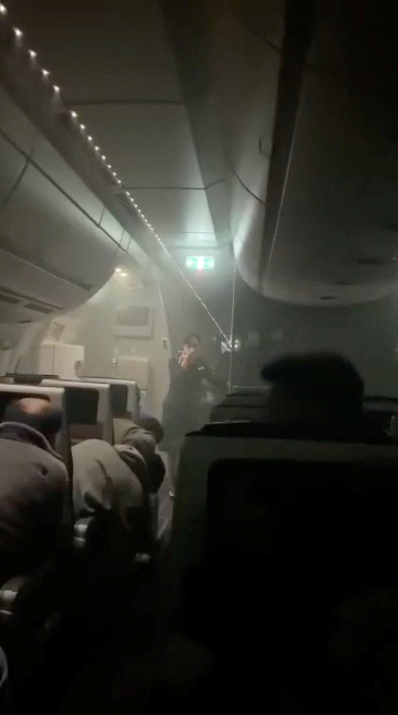 JAPAN-AIRPORT/FIRE People sit amid smoke inside the Japan Airlines' A350 airplane in this screen grab obtained from social media video. Video Obtained by Reuters/via REUTERS THIS IMAGE HAS BEEN SUPPLIED BY A THIRD PARTY.