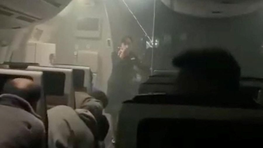 People sit amid smoke inside the Japan Airlines' A350 airplane in this screen grab obtained from social media video. Video Obtained by Reuters/via REUTERS  THIS IMAGE HAS BEEN SUPPLIED BY A THIRD PARTY.