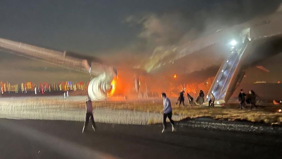 People sit amid smoke inside the Japan Airlines' A350 airplane in this screen grab obtained from social media video. Video Obtained by Reuters/via REUTERS  THIS IMAGE HAS BEEN SUPPLIED BY A THIRD PARTY.
