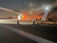 A Japan Airlines (JAL) plane sits on fire after it collided with a Coast Guard aircraft on the ground at Tokyo's Haneda airport, Japan, January 2, 2024 in this image obtained from social media. Obtained by Reuters/via REUTERS  THIS IMAGE HAS BEEN SUP