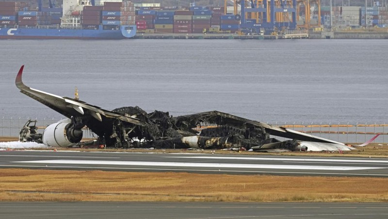 This aerial photo show the burn-out Japan Airlines plane at Haneda airport on Wednesday, Jan. 3, 2024, in Tokyo, Japan. The large passenger plane and a Japanese coast guard aircraft collided on the runway at Tokyo's Haneda Airport on Tuesday and burst into flames, killing several people aboard the coast guard plane, officials said. (Kyodo News via AP)