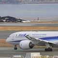 The burn-out Japan Airlines plane is seen, at rear, at Haneda airport on Wednesday, Jan. 3, 2024, in Tokyo, Japan. The large passenger plane and a Japanese coast guard aircraft collided on the runway at Tokyo's Haneda Airport on Tuesday and burst int