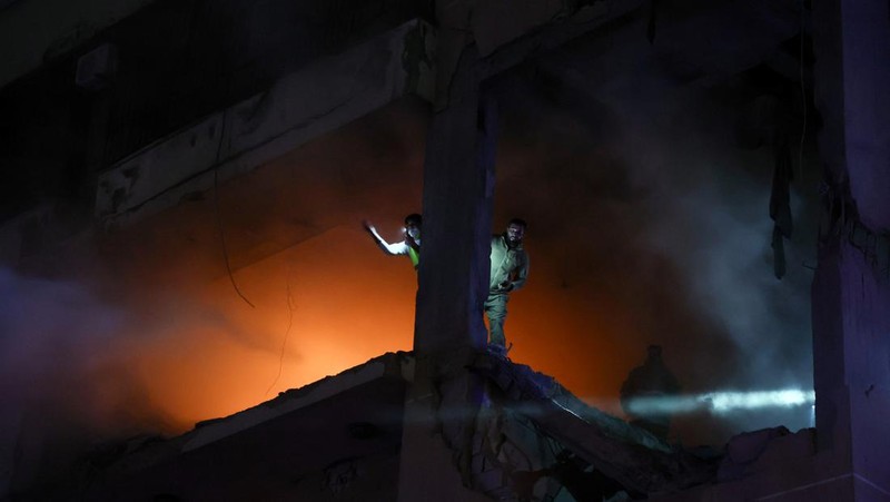 People gather near a damaged site following an explosion, in what security sources say is an Israeli drone strike, at the Beirut suburb of Dahiyeh, Lebanon January 2, 2024. REUTERS/Mohamed Azakir
