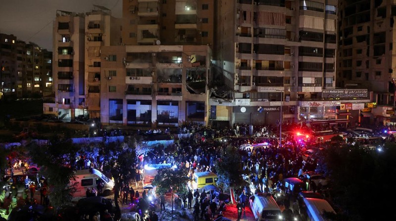 People gather near a damaged site following an explosion, in what security sources say is an Israeli drone strike, at the Beirut suburb of Dahiyeh, Lebanon January 2, 2024. REUTERS/Mohamed Azakir