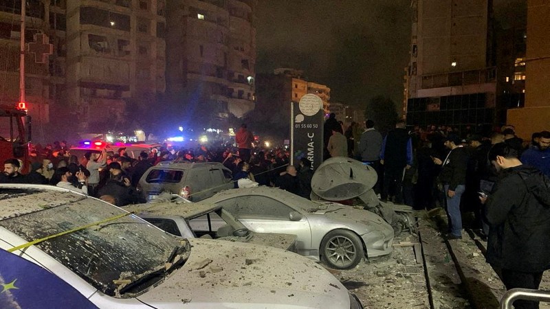 People gather near a damaged site following an explosion, in what security sources say is an Israeli drone strike, at the Beirut suburb of Dahiyeh, Lebanon January 2, 2024. REUTERS/Mohamed Azakir