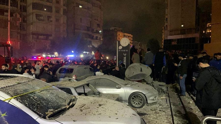 People gather near a damaged site following an explosion, in what security sources say is an Israeli drone strike, at the Beirut suburb of Dahiyeh, Lebanon January 2, 2024. REUTERS/Mohamed Azakir