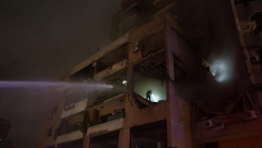 People gather near a damaged site following an explosion, in what security sources say is an Israeli drone strike, at the Beirut suburb of Dahiyeh, Lebanon January 2, 2024. REUTERS/Mohamed Azakir