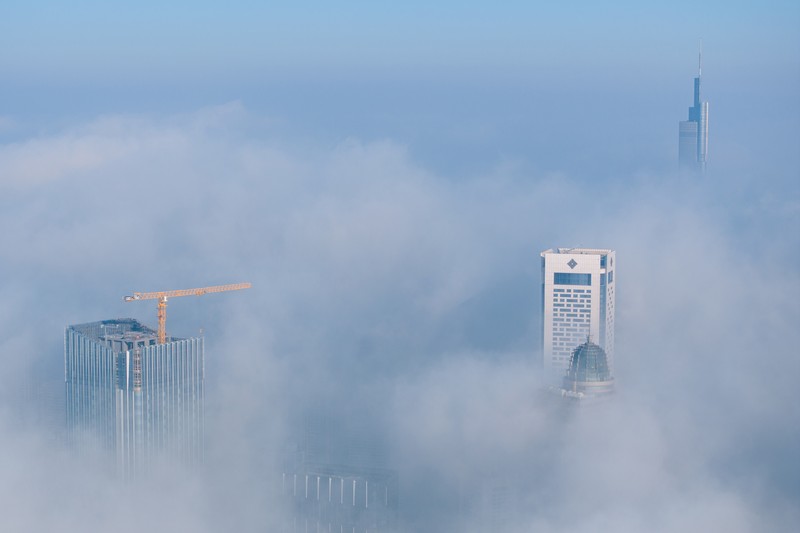 1898128709 NANJING, CHINA - JANUARY 4, 2024 - Aerial photo shows skyscrapers looming in heavy fog in the main urban area of Nanjing, East China's Jiangsu province, Jan 4, 2024. (Photo credit should read CFOTO/Future Publishing via Getty Images)