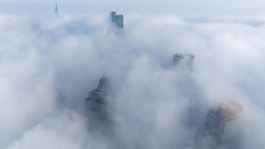 NANJING, CHINA - JANUARY 4, 2024 - Aerial photo shows skyscrapers looming in heavy fog in the main urban area of Nanjing, East China's Jiangsu province, Jan 4, 2024. (Photo credit should read CFOTO/Future Publishing via Getty Images)