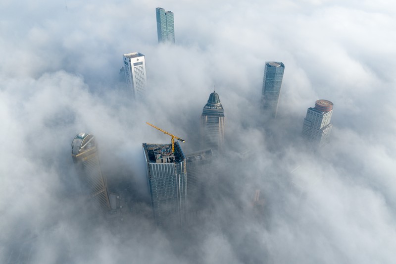 1898128709 NANJING, CHINA - JANUARY 4, 2024 - Aerial photo shows skyscrapers looming in heavy fog in the main urban area of Nanjing, East China's Jiangsu province, Jan 4, 2024. (Photo credit should read CFOTO/Future Publishing via Getty Images)