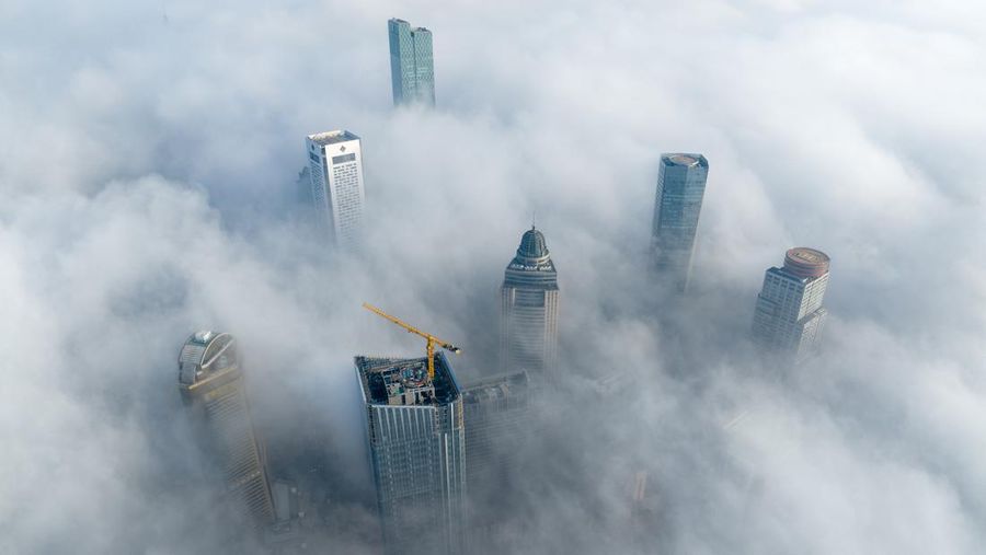 NANJING, CHINA - JANUARY 4, 2024 - Aerial photo shows skyscrapers looming in heavy fog in the main urban area of Nanjing, East China's Jiangsu province, Jan 4, 2024. (Photo credit should read CFOTO/Future Publishing via Getty Images)