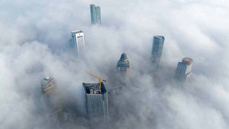 NANJING, CHINA - JANUARY 4, 2024 - Aerial photo shows skyscrapers looming in heavy fog in the main urban area of Nanjing, East China's Jiangsu province, Jan 4, 2024. (Photo credit should read CFOTO/Future Publishing via Getty Images)