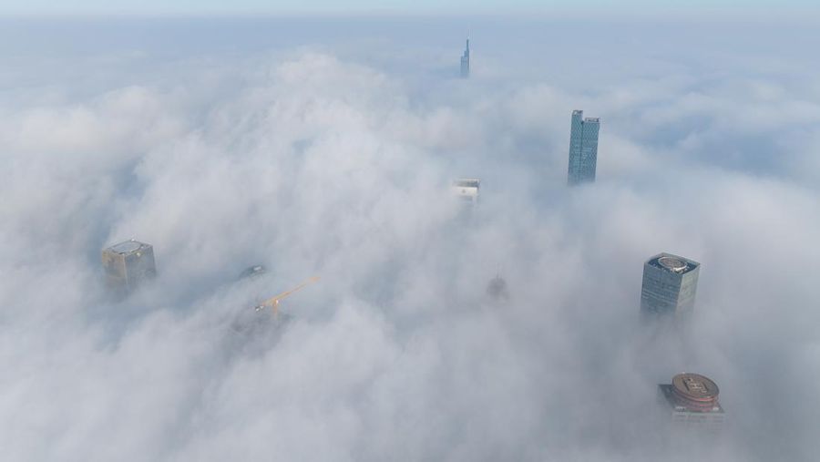 NANJING, CHINA - JANUARY 4, 2024 - Aerial photo shows skyscrapers looming in heavy fog in the main urban area of Nanjing, East China's Jiangsu province, Jan 4, 2024. (Photo credit should read CFOTO/Future Publishing via Getty Images)