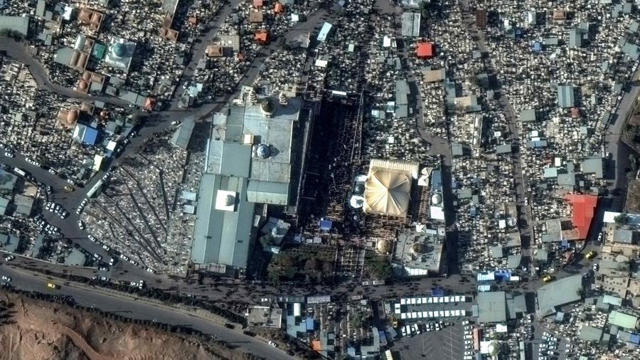 This image, provided by Maxar Technologies, shows cars and buses near the martyr's cemetery in Kerman, Iran Wednesday, Jan. 3, 2024 before, according to Iranian authorities, twin bomb blasts killed at least 103 people at an event honoring a prominent Iranian general slain in a U.S. airstrike in 2020. (Satellite image ©2023 Maxar Technologies via AP)