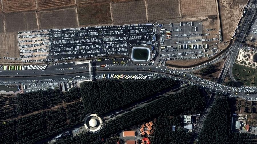 This image, provided by Maxar Technologies, shows cars and buses near the martyr's cemetery in Kerman, Iran Wednesday, Jan. 3, 2024 before, according to Iranian authorities, twin bomb blasts killed at least 103 people at an event honoring a prominent Iranian general slain in a U.S. airstrike in 2020. (Satellite image ©2023 Maxar Technologies via AP)