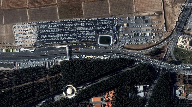 This image, provided by Maxar Technologies, shows cars and buses near the martyr's cemetery in Kerman, Iran Wednesday, Jan. 3, 2024 before, according to Iranian authorities, twin bomb blasts killed at least 103 people at an event honoring a prominent Iranian general slain in a U.S. airstrike in 2020. (Satellite image ©2023 Maxar Technologies via AP)