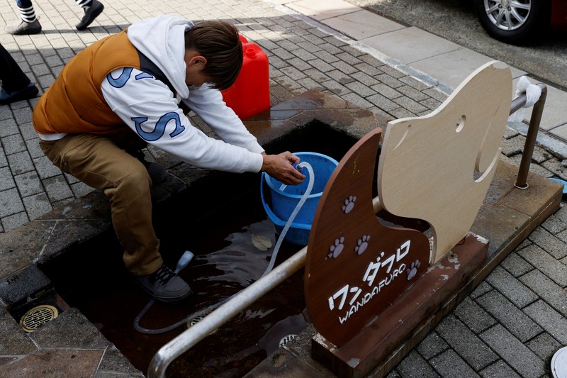 Residents stand in a line to get food from a volunteer group, in the aftermath of an earthquake, in Wajima, Ishikawa Prefecture, Japan, January 4, 2024. REUTERS/Kim Kyung-Hoon