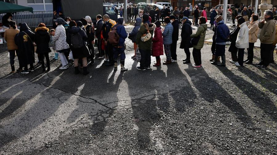 Residents stand in a line to get food from a volunteer group, in the aftermath of an earthquake, in Wajima, Ishikawa Prefecture, Japan, January 4, 2024. REUTERS/Kim Kyung-Hoon