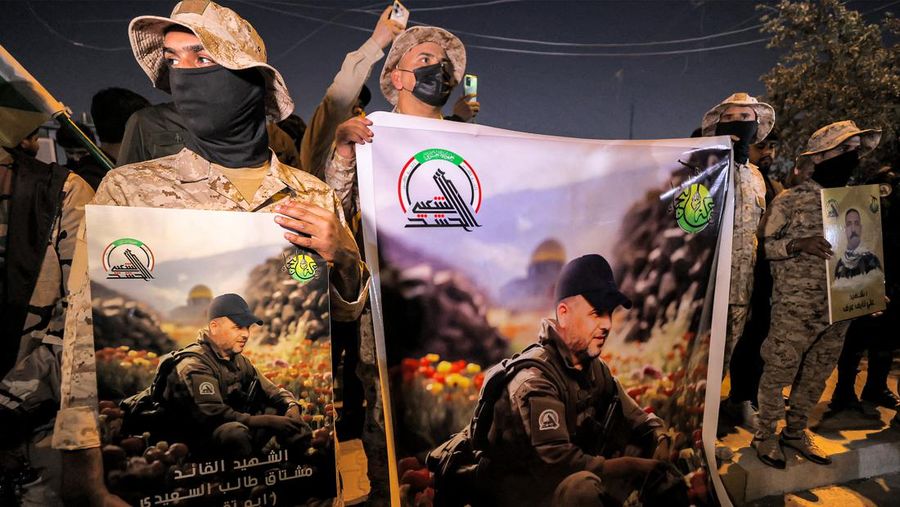 Members of Iraq's Popular Mobilisation Forces (PMF) paramilitaries carry the bodies of two of their slain comrades during their funeral at the PMF headquarters in Baghdad on January 4, 2024. A US strike in Baghdad on January 4 killed a military commander of the PMF, an ex-paramilitary faction of the grouping said, with an Iraqi security official reporting two deaths in a drone attack. Harakat al-Nujaba, one of the PMF's factions, said in a statement that 