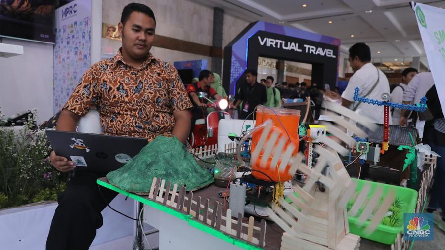 Siswa Madrasah Aliyah Negeri (MAN) 9 Jakarta mengoperasikan Soccer Robot saat acara Devotion Experience (Dev-X) di Jakarta Convention Center (JCC), Senayan Jakarta, Jumat (5/1/2024). (CNBC Indonesia/Faisal Rahman)