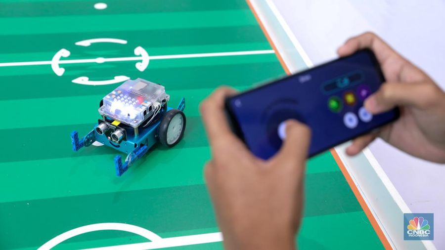Siswa Madrasah Aliyah Negeri (MAN) 9 Jakarta mengoperasikan Soccer Robot saat acara Devotion Experience (Dev-X) di Jakarta Convention Center (JCC), Senayan Jakarta, Jumat (5/1/2024). (CNBC Indonesia/Faisal Rahman)