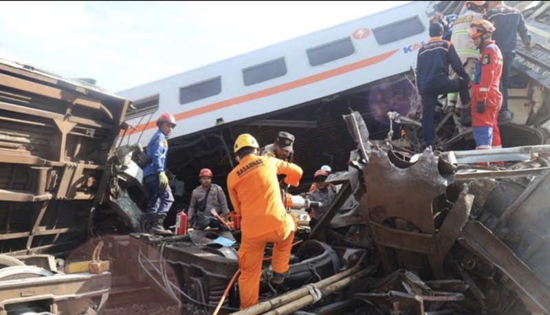 Indonesia Train Crash Tim penyelamat berjalan di dekat puing-puing kereta api setelah tabrakan di Cicalengka, Jawa Barat, Indonesia, Jumat, 5 Januari 2024. Kedua kereta itu bertabrakan di pulau utama Indonesia, Jawa, pada hari Jumat, menyebabkan beberapa gerbong tertekuk dan terbalik. (AP Photo/Abdan Syakura)