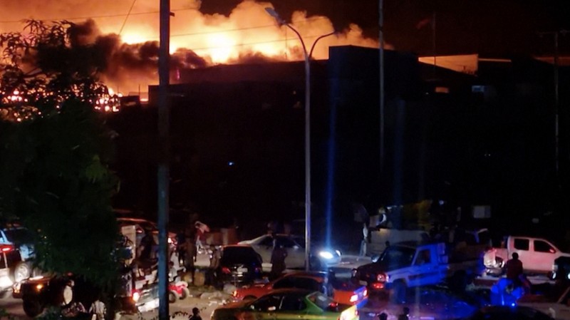 Orang-orang berkumpul di dekat sebuah gedung, di tengah laporan penjarahan dan pembakaran yang meluas ketika polisi dan sektor publik memprotes pemotongan gaji yang menurut para pejabat disebabkan oleh kesalahan administratif, di Port Moresby, Papua Nugini, 10 Januari 2024, dalam tangkapan layar yang diperoleh dari sebuah video. (Mackenzie Waide/via REUTERS)