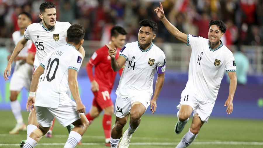 Indonesia's Asnawi Mangkualam Bahar, center, celebrates after scoring the opening goal from the penalty spot during the Asian Cup Group D soccer match between Vietnam and Indonesia at Abdullah Bin Khalifa Stadium in Doha, Qatar, Friday, Jan. 19, 2024. (AP Photo/Hussein Sayed)