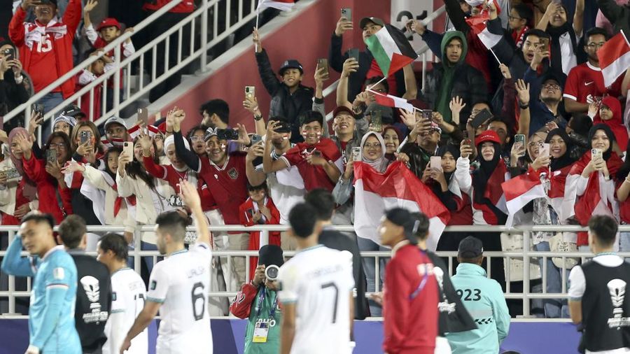 Fans watch the Asian Cup Group D soccer match between Vietnam and Indonesia at Abdullah Bin Khalifa Stadium in Doha, Qatar, Friday, Jan. 19, 2024. (AP Photo/Hussein Sayed)