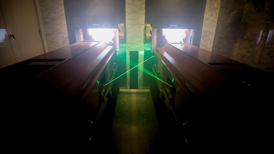 A couple of gamers, Miriam Castella and Carlos Granedo, participate in an extreme escape room named Catalepsia, which takes place inside two coffins simulating their funeral and trying to escape from them by working in pairs to solve puzzles and tricks, in Barcelona, Spain, January 18, 2024. REUTERS/ Albert Gea