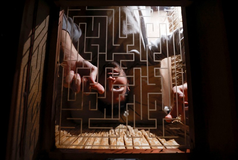 A couple of gamers, Miriam Castella and Carlos Granedo, participate in an extreme escape room named Catalepsia, which takes place inside two coffins simulating their funeral and trying to escape from them by working in pairs to solve puzzles and tricks, in Barcelona, Spain, January 18, 2024. REUTERS/ Albert Gea